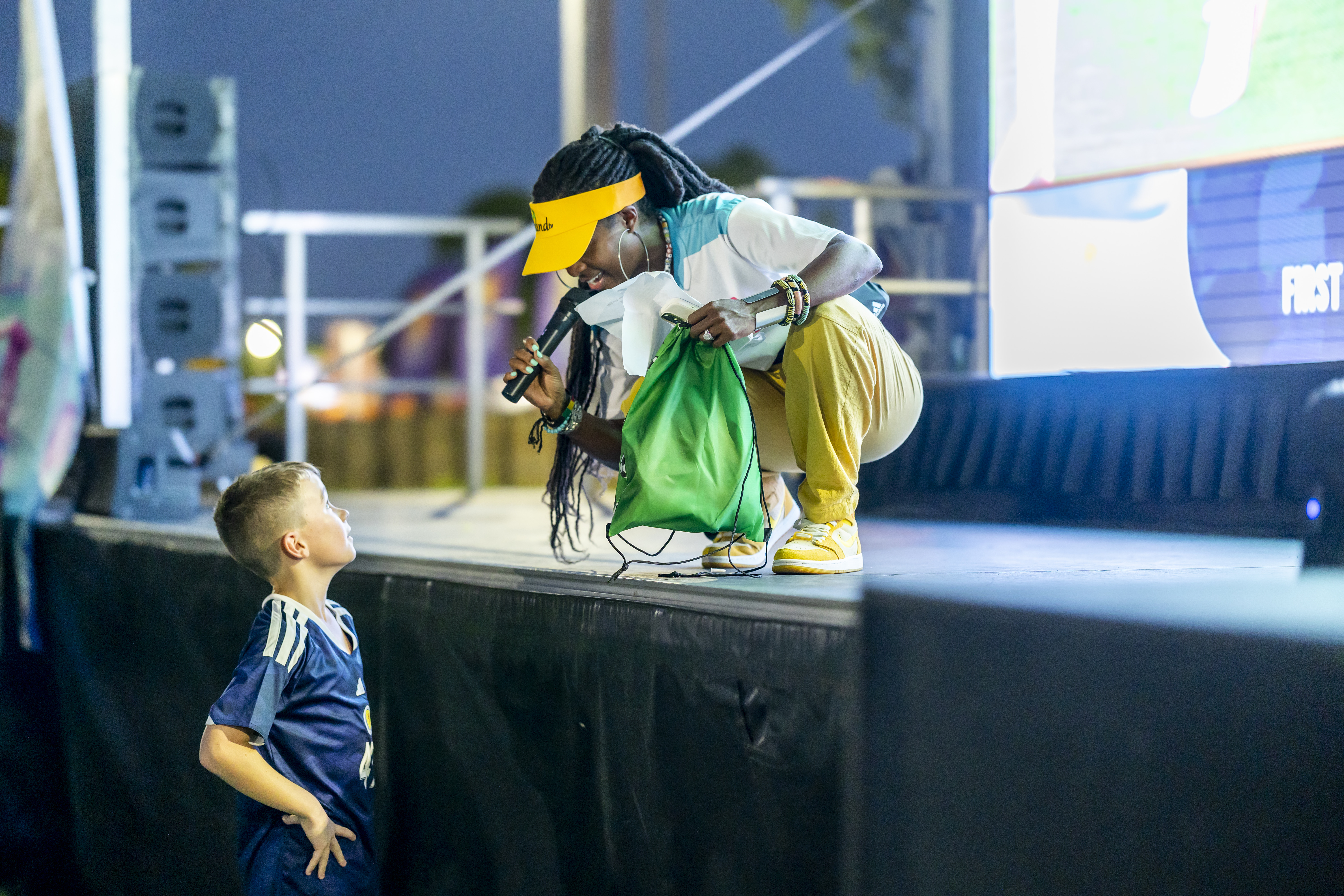 Host with kid on stage